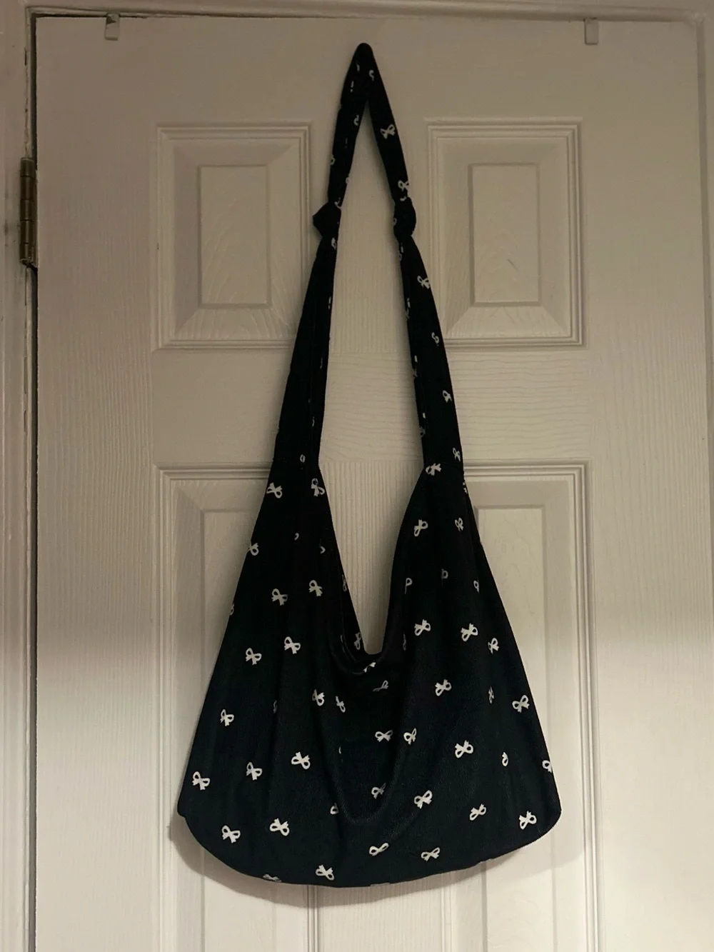 Classic Black Sling Shoulder Bag with White Bow Print